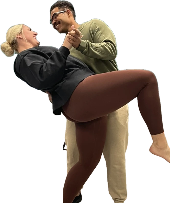 A couple practicing a dip during a private wedding dance lesson at The Movement