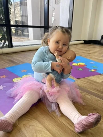 A Bravo Babies dancer with her baby doll in class