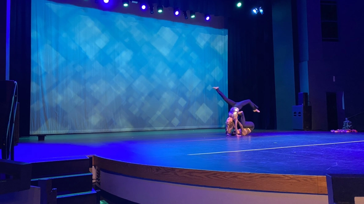 Company duet dancers performing a floor partnering move