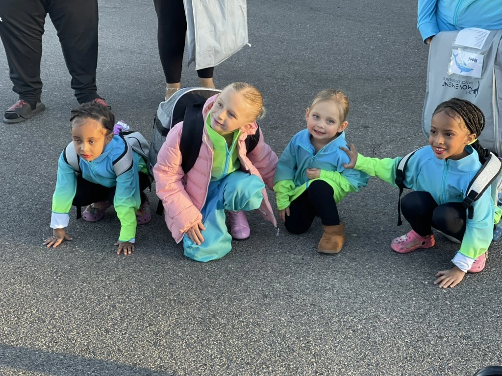 Mini company dancers in matching ombre team jackets