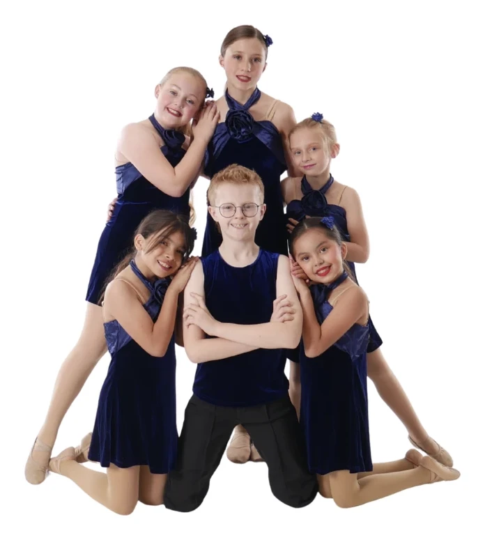 Company dancers in navy velvet costumes posing together