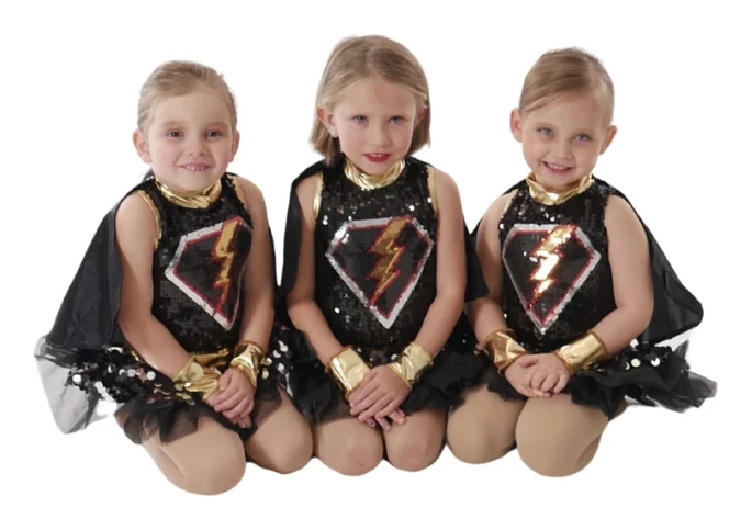 Three mini Company dancers in sparkly superhero costumes