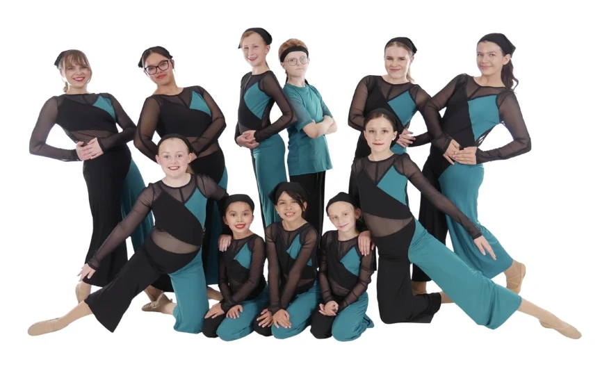 The Movement Dance Company cast posing together in matching teal and black costumes
