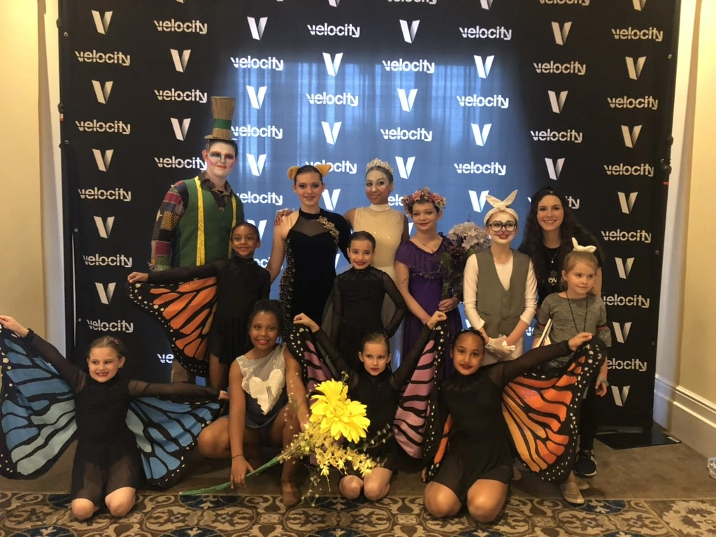 Company dancers in butterfly wings and storybook costumes at Velocity