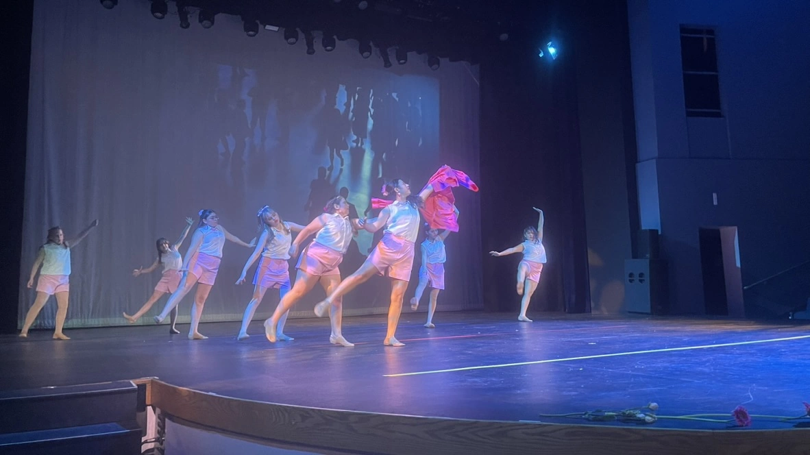 The Movement Dance Company dancing with a flowing pink scarf on stage