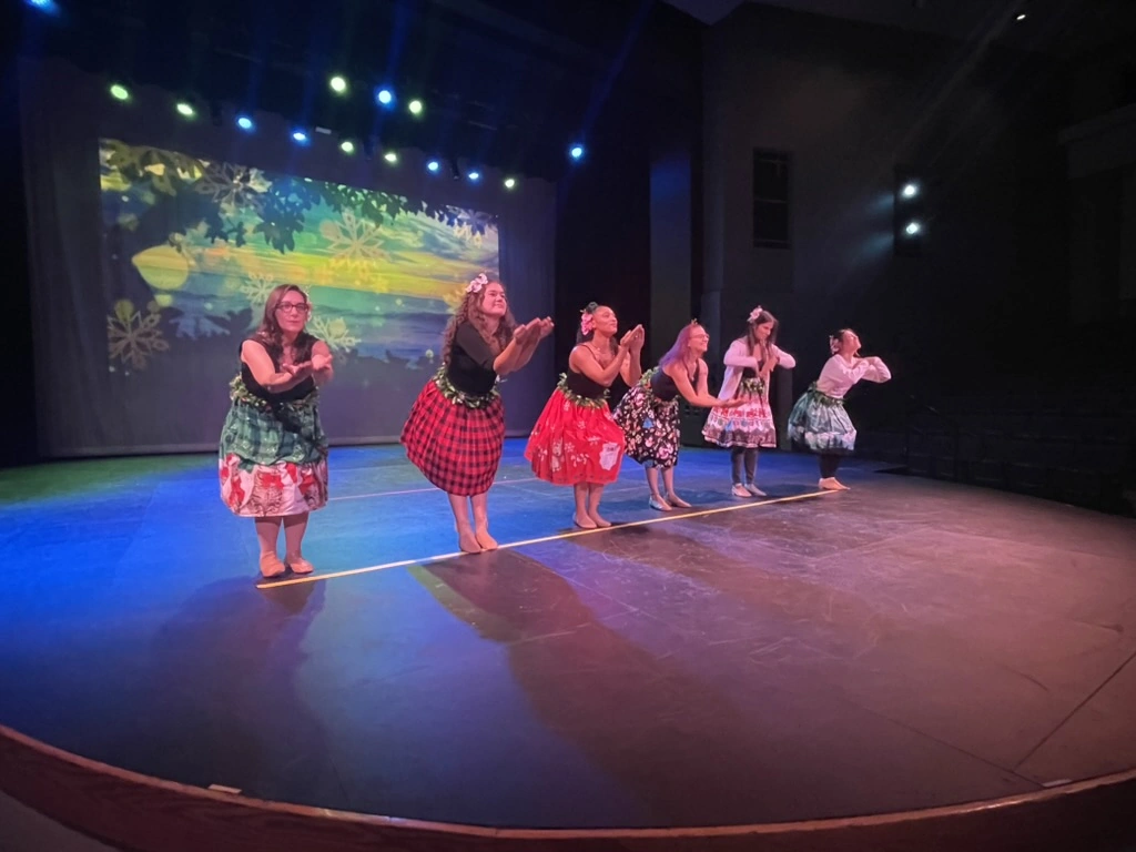 Encore adult dancers performing a hula line on the Ovation Theatre stage