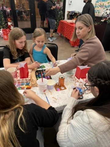 Families making holiday crafts together at a Movement community event