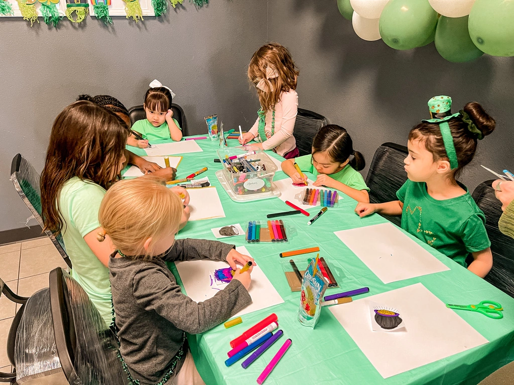 Kids coloring together at a Movement St. Patrick's Day party