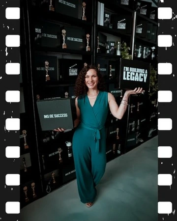 Mandy Saul with her I am Building a Legacy sign at Inside Success TV
