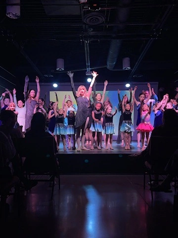 The whole cast celebrating the finale at Ovation Theatre