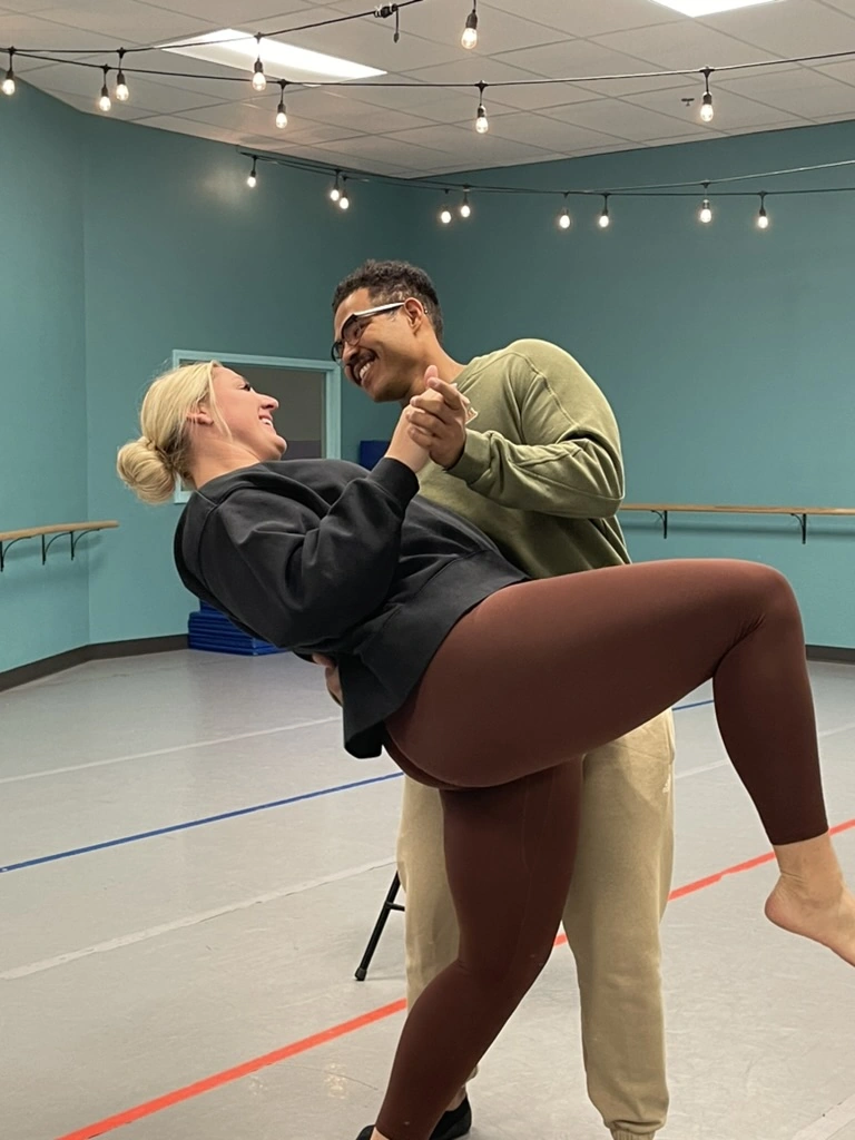 A couple practicing a dip in a private lesson at The Movement